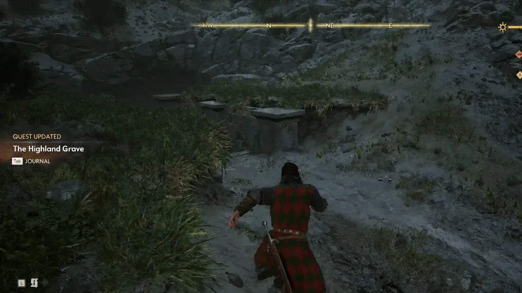 Coen approaching the weathered stone entrance of the Highland Grave ruins in the mountains