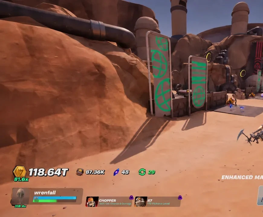 Player exploring the expanded desert area beside large industrial structures