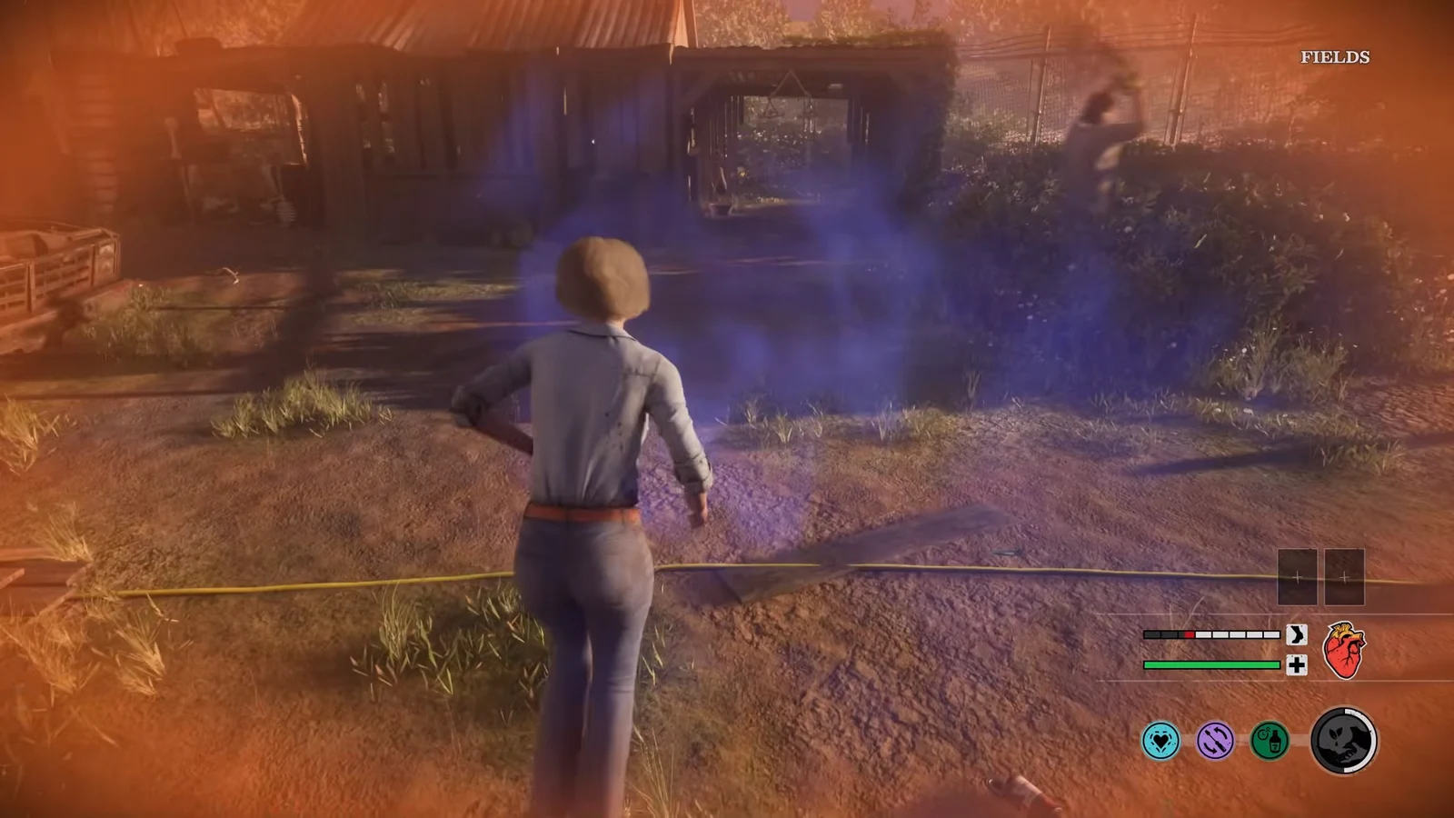 Injured victim running toward a shed in the Fields area with a red damage vignette on screen