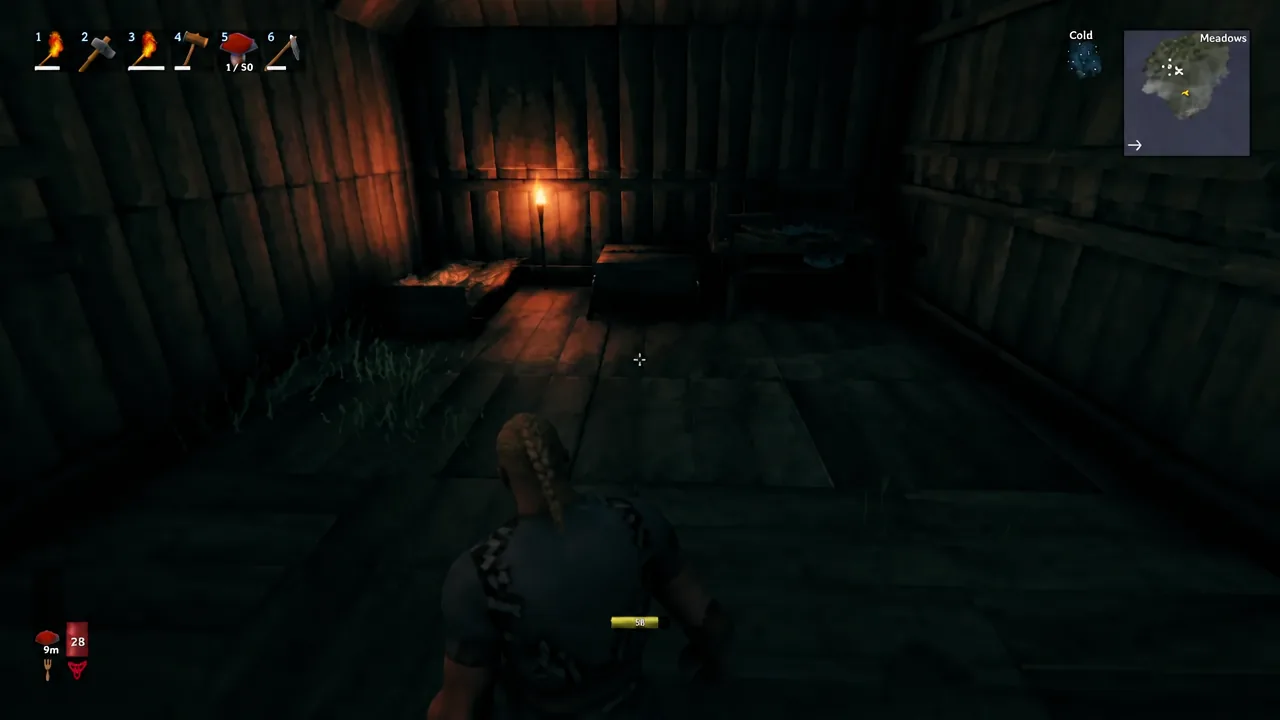 Viking character walking through a torch-lit wooden shelter with beds in the Meadows