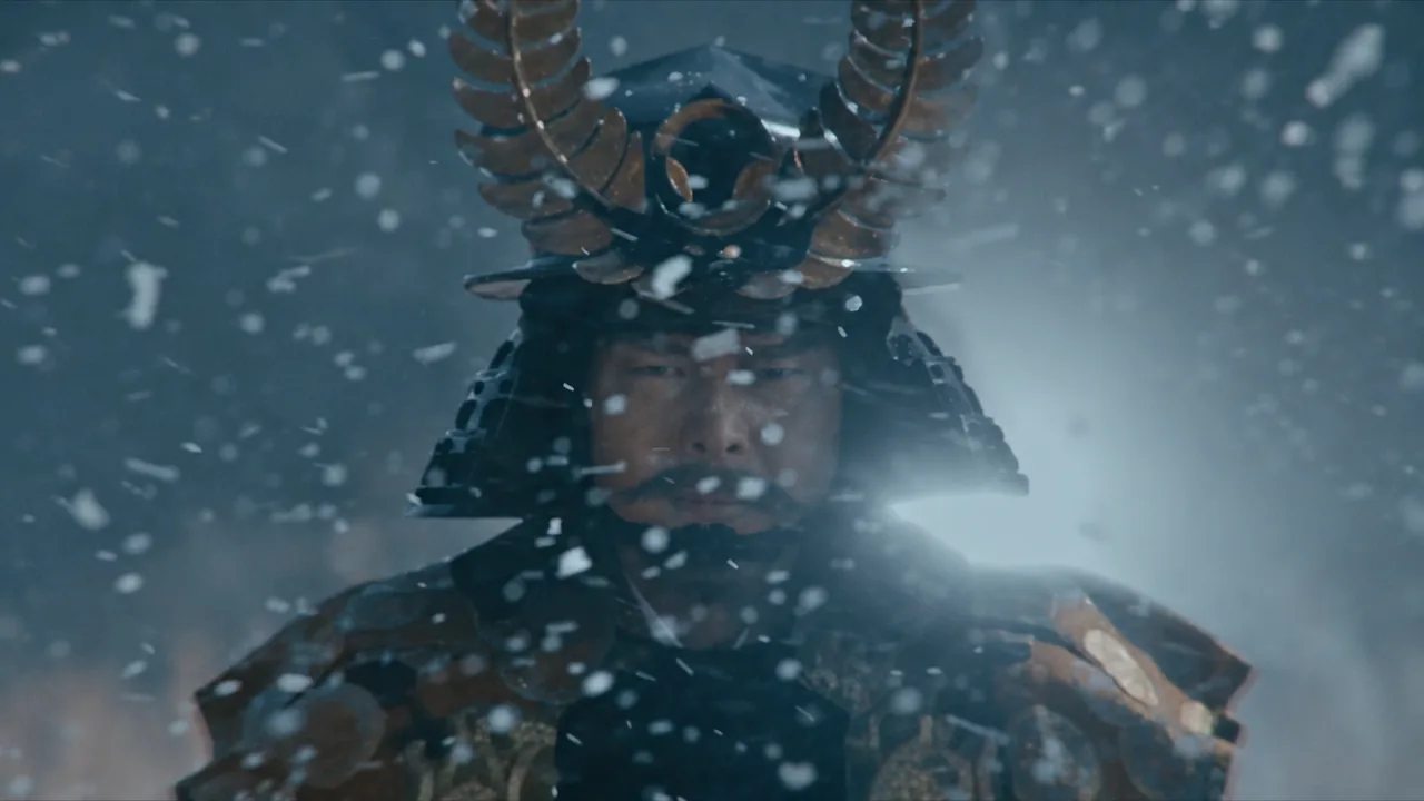 Tokugawa commander in dark armour and a golden crescent-horned helmet standing in falling snow