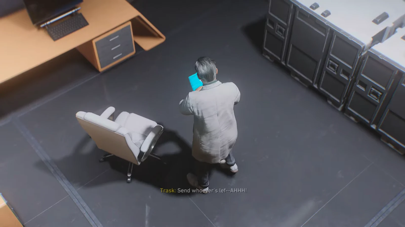 Trask on a blue phone beside his office chair as subtitles read Send whoever's left
