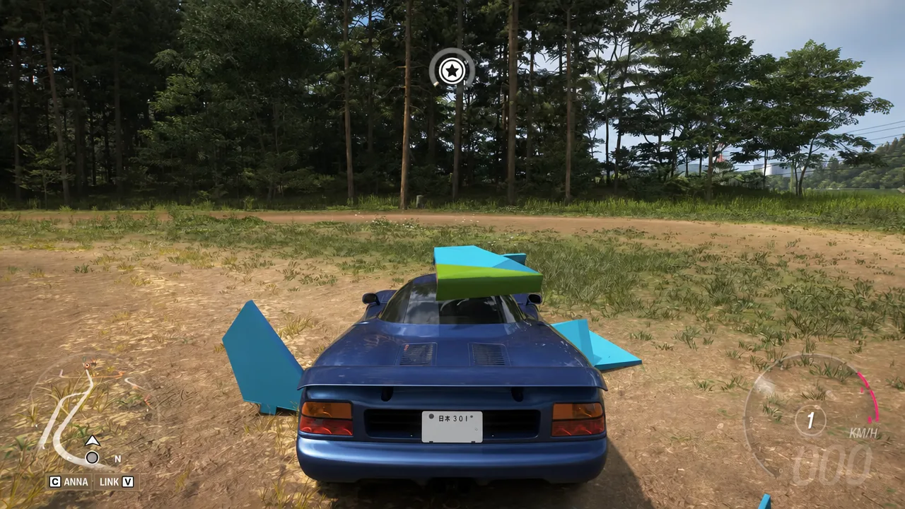 Blue sports car sitting almost stationary on a dirt clearing near the treasure chest site