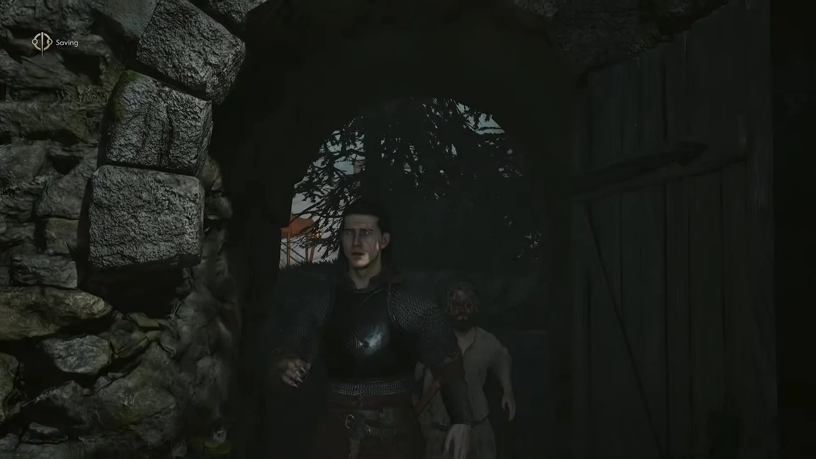 Coen and his companion inside a dark stone passage as the game autosaves