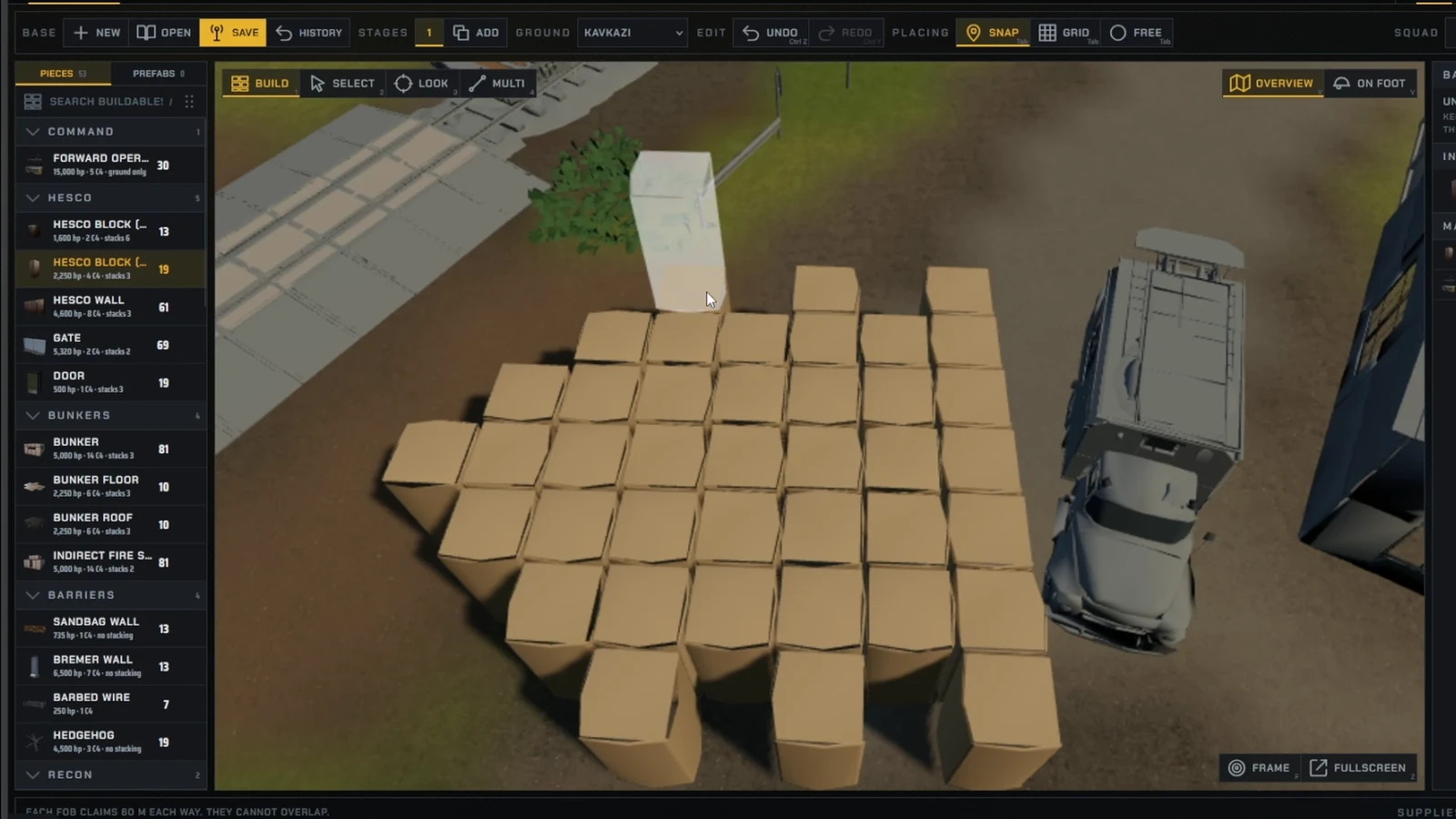 Build mode placing HESCO Block pieces in layers around parked vehicles inside a base