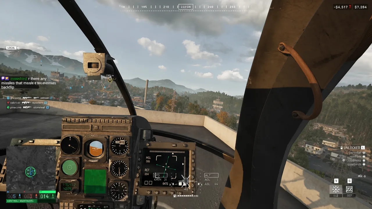 Helicopter flight instruments and HUD visible from the cockpit during a low pass over a built-up area