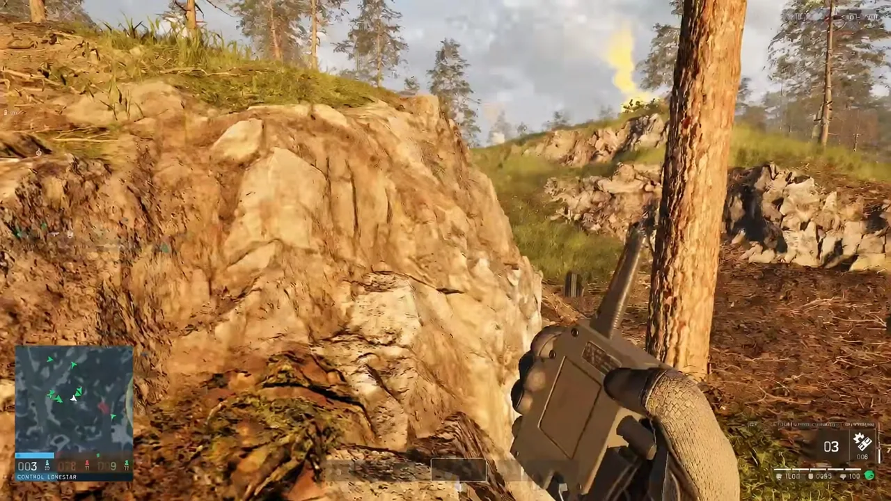 First-person view of a handheld radio equipped while the player crouches behind a rock