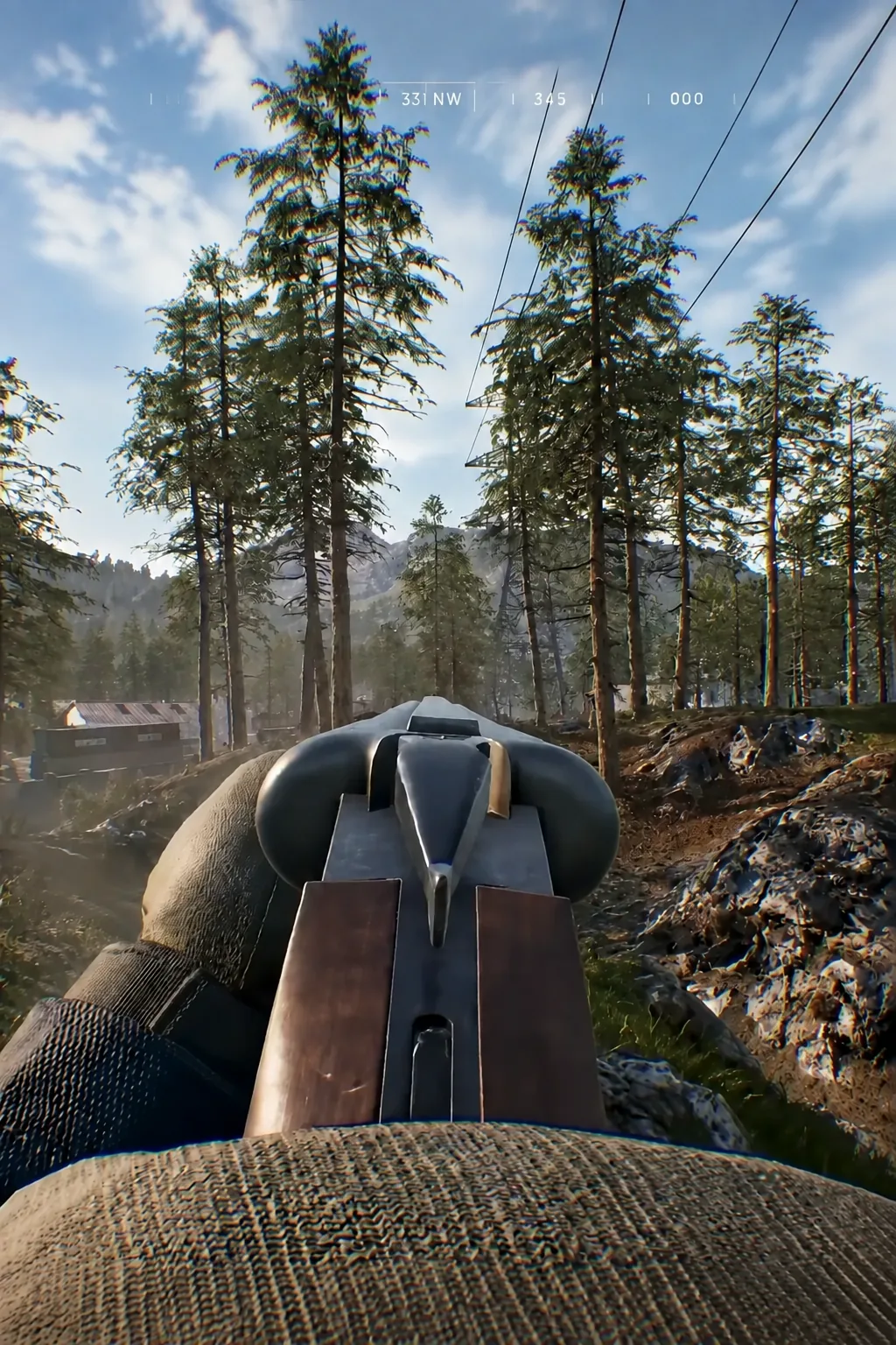 First-person view lining up a shot through thick forest, compass heading shown along the top of the HUD