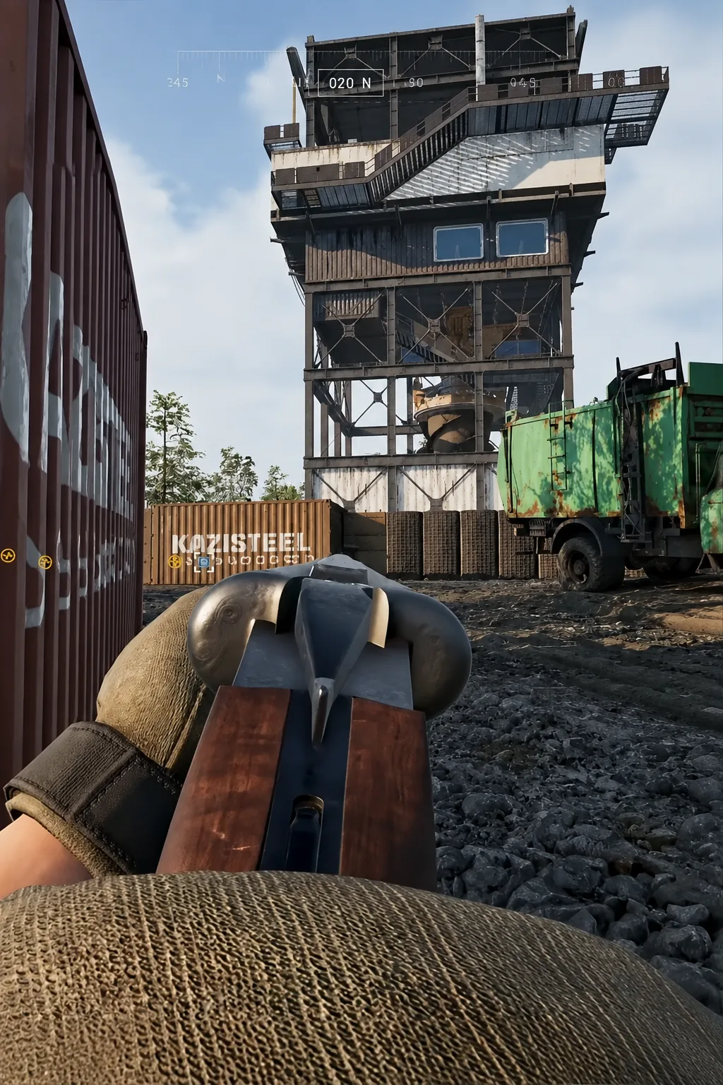 Player aims an equipped weapon at an industrial tower structure, compass reading 020 N