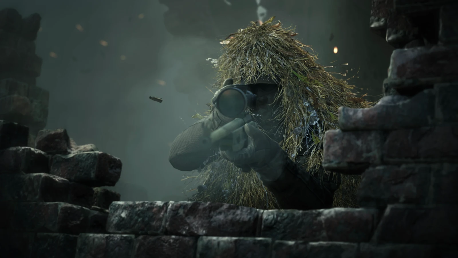 A ghillie-suited sniper takes cover behind a crumbling stone wall in a smoky battlefield during daylight.