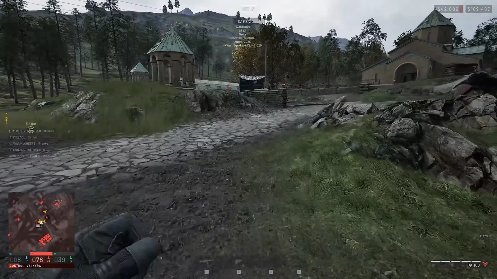 First-person view moving unarmed through the WARDOGS safe zone toward a monastery