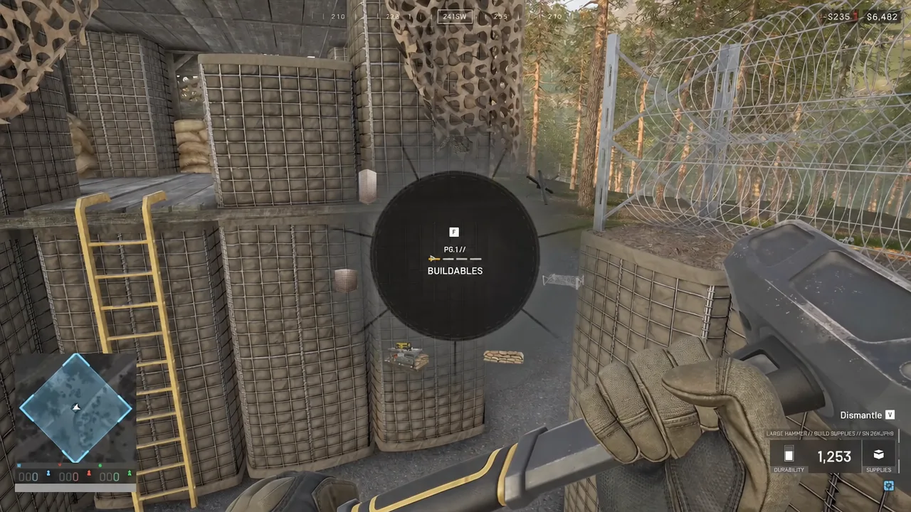 BUILDABLES key prompt showing while the player holds a large hammer next to a fortification