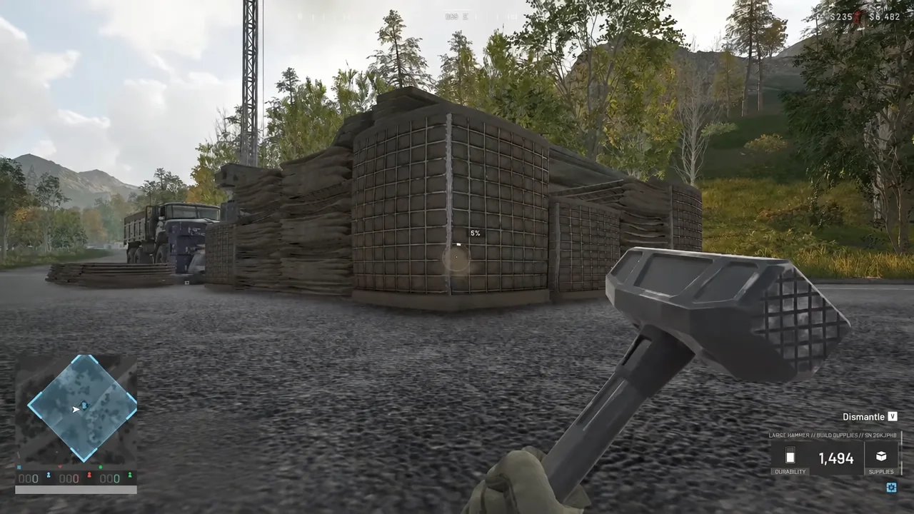 Hammer equipped with the Dismantle prompt highlighted over a sandbag fortification