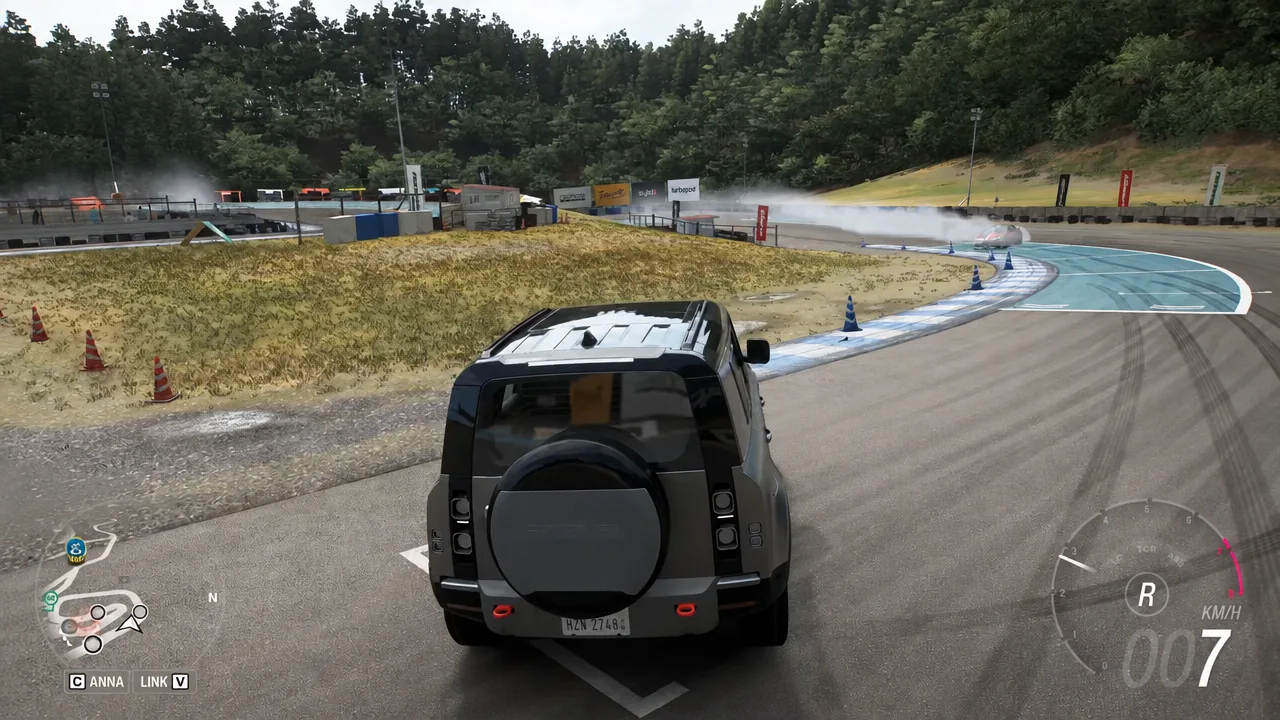 The Defender manoeuvring in reverse on the wet Shimanoyama Drift Circuit