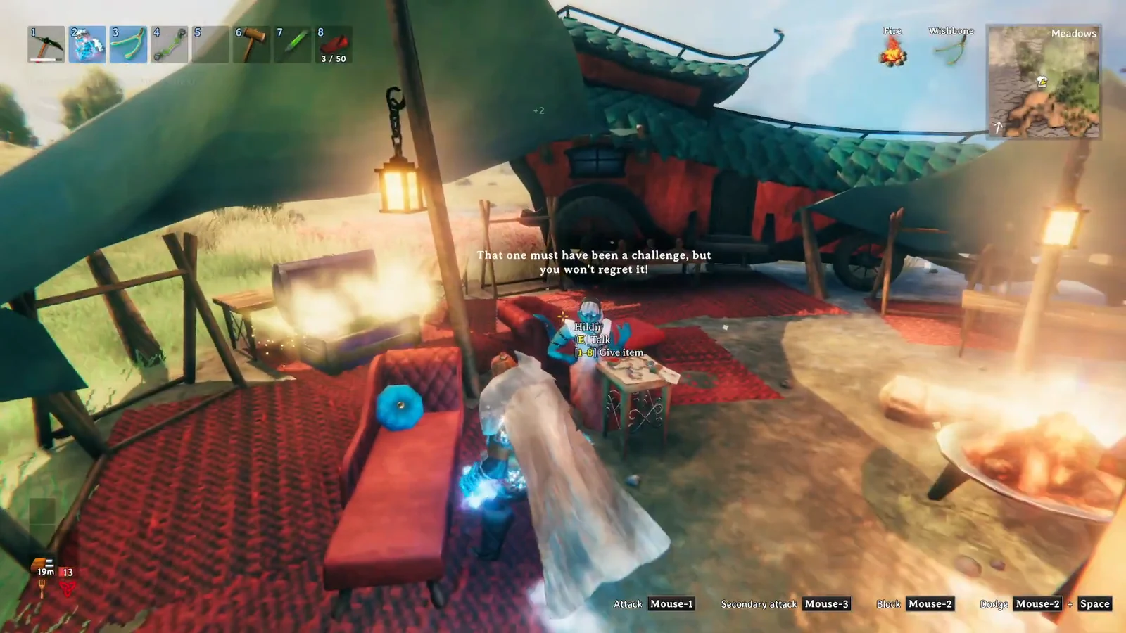 Hildir standing in her camp with the Talk and Give item interaction prompts on screen