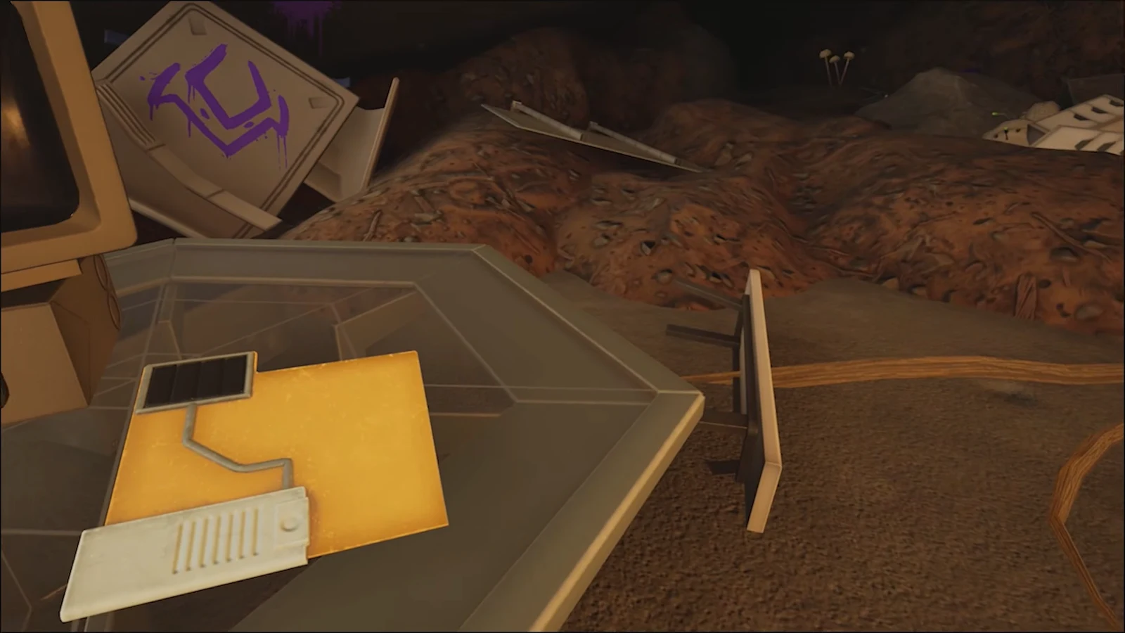 First-person view of a yellow electrical panel attached to wreckage inside the cave