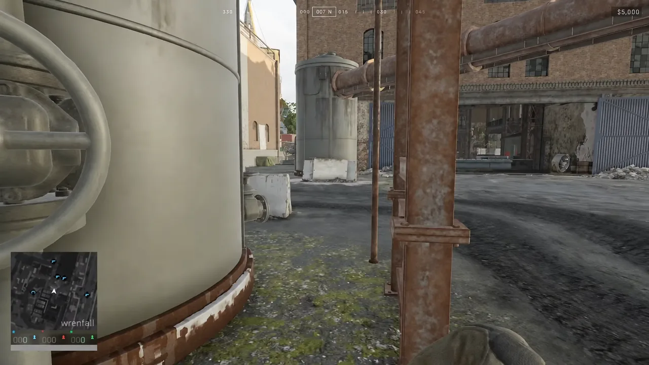First-person view running through the Firing Range industrial yard with the minimap in the corner