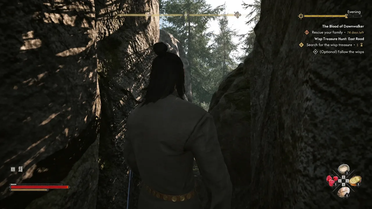 The Wisp Treasure Hunt East Road objective on screen as Coen walks through a narrow rocky passage