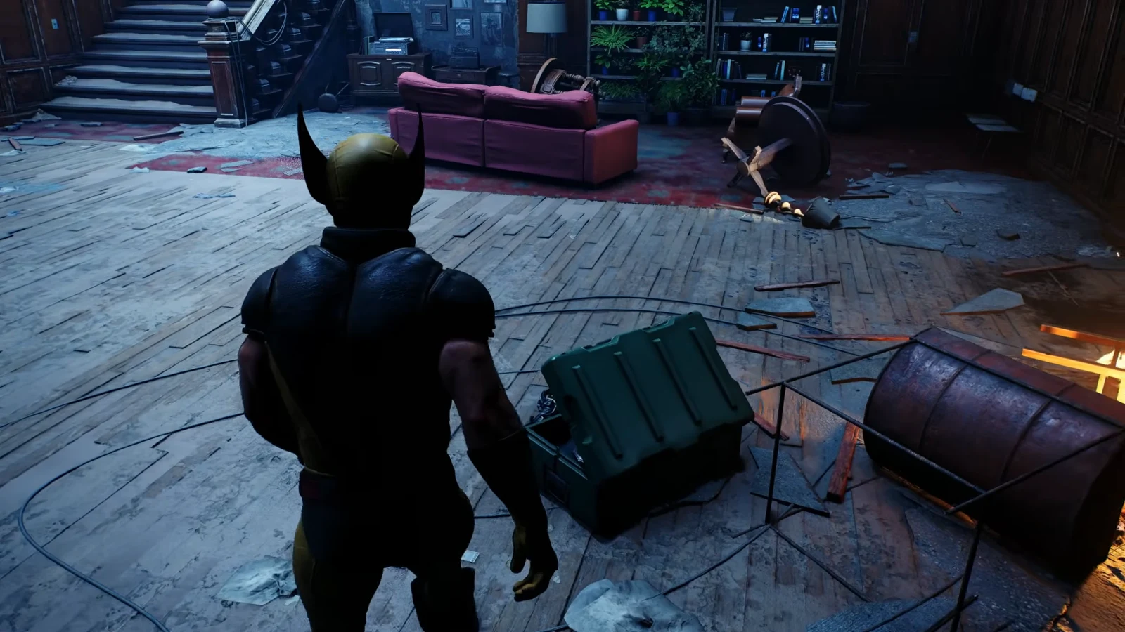 Wolverine standing beside an opened green crate inside the wrecked mansion during the investigation objective