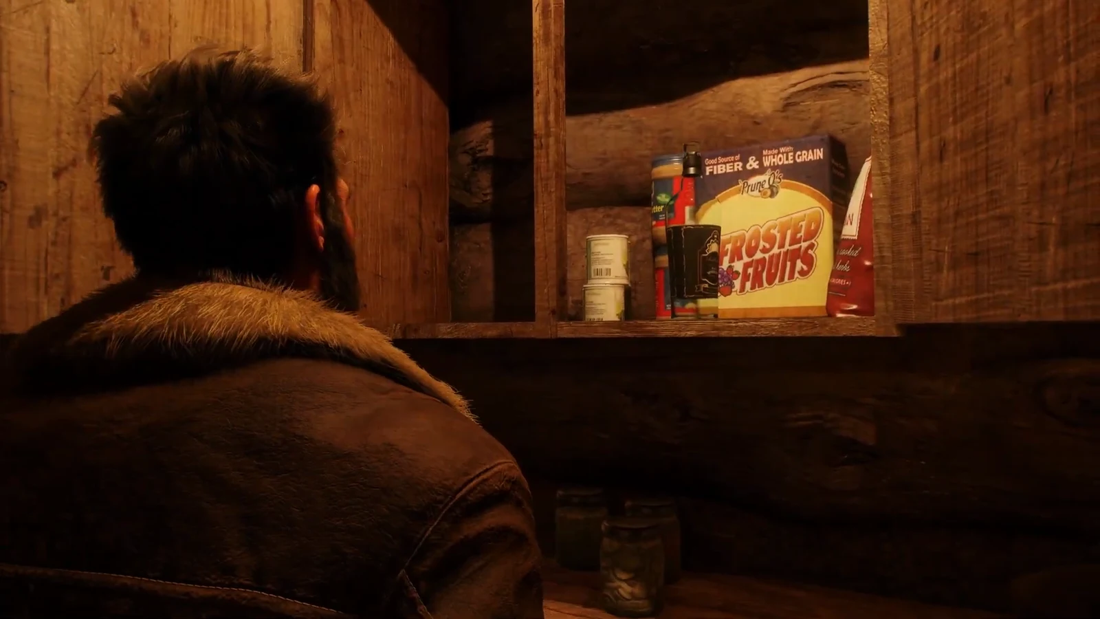 Logan opening the footlocker inside his cabin to find a fresh bottle of whiskey