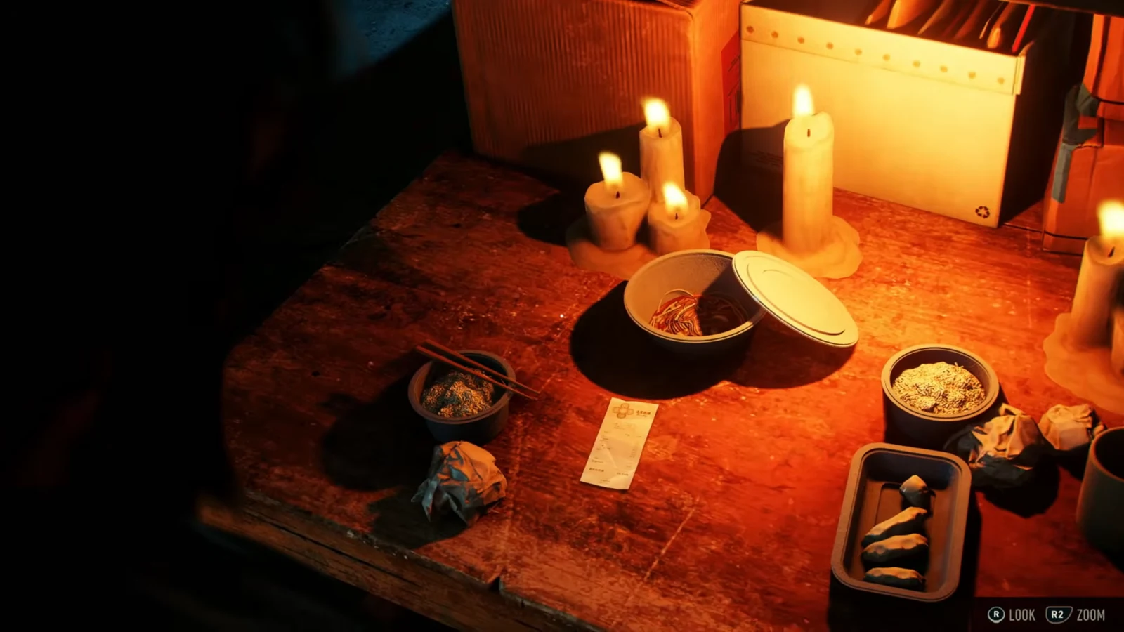 Close inspection of a candlelit table with takeout bowls and a ramen delivery receipt