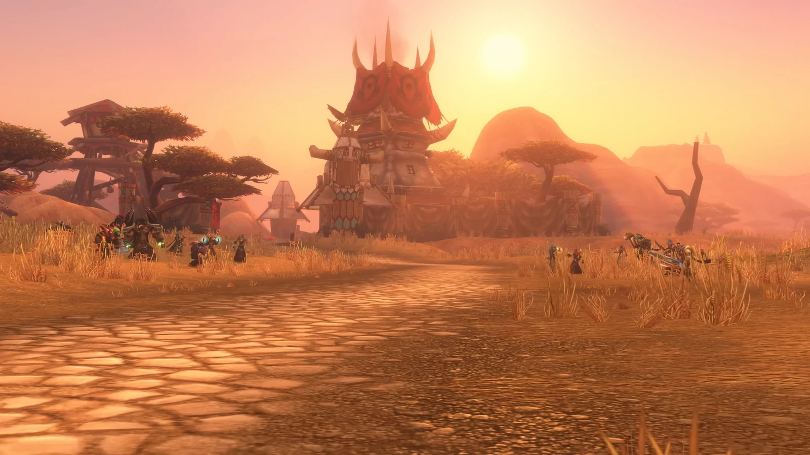 A Horde settlement with a towering fortress, baobab trees, and distant hills sits along a sunlit road at sunset.