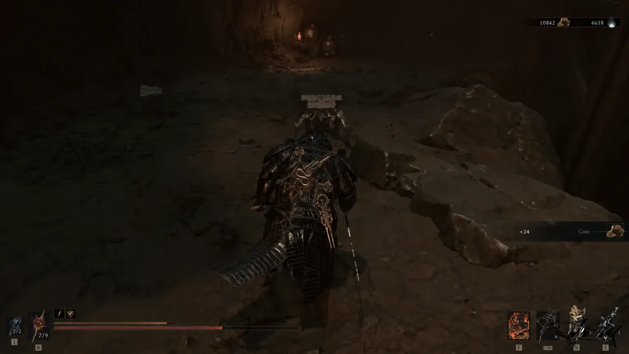 Player character moving through a cave tunnel as a coin pickup notification appears
