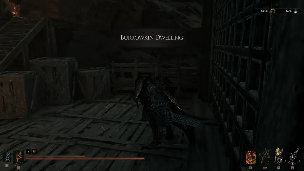 The Burrowkin Dwelling area name appearing on screen inside a dark wooden mine interior