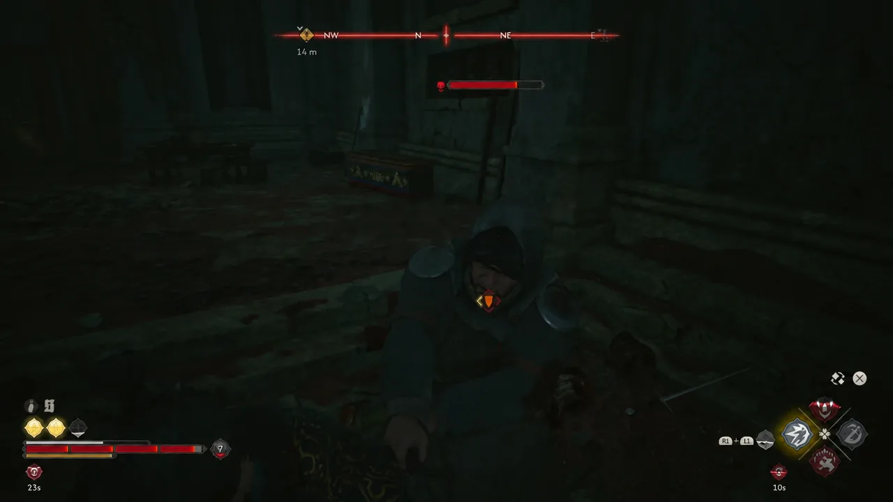 Locked-on combat inside the cave with an orange marker over a hooded enemy