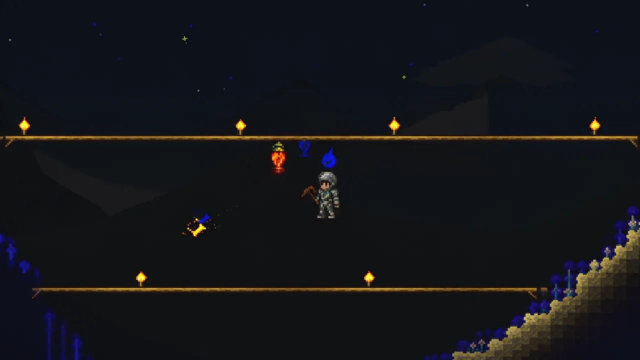 Player mid-jump with a pickaxe between torch-lit underground platforms in Terraria
