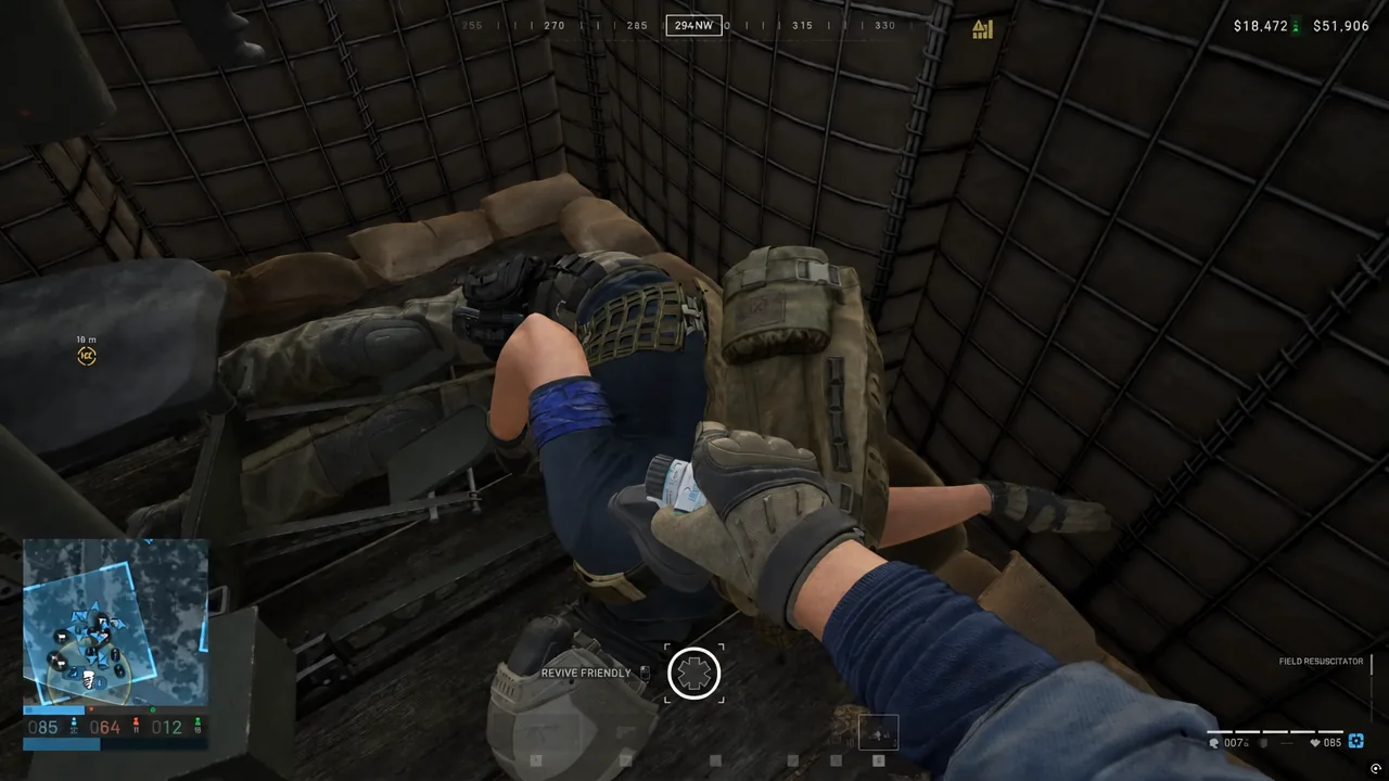 First-person view of the REVIVE FRIENDLY prompt while picking up a downed teammate