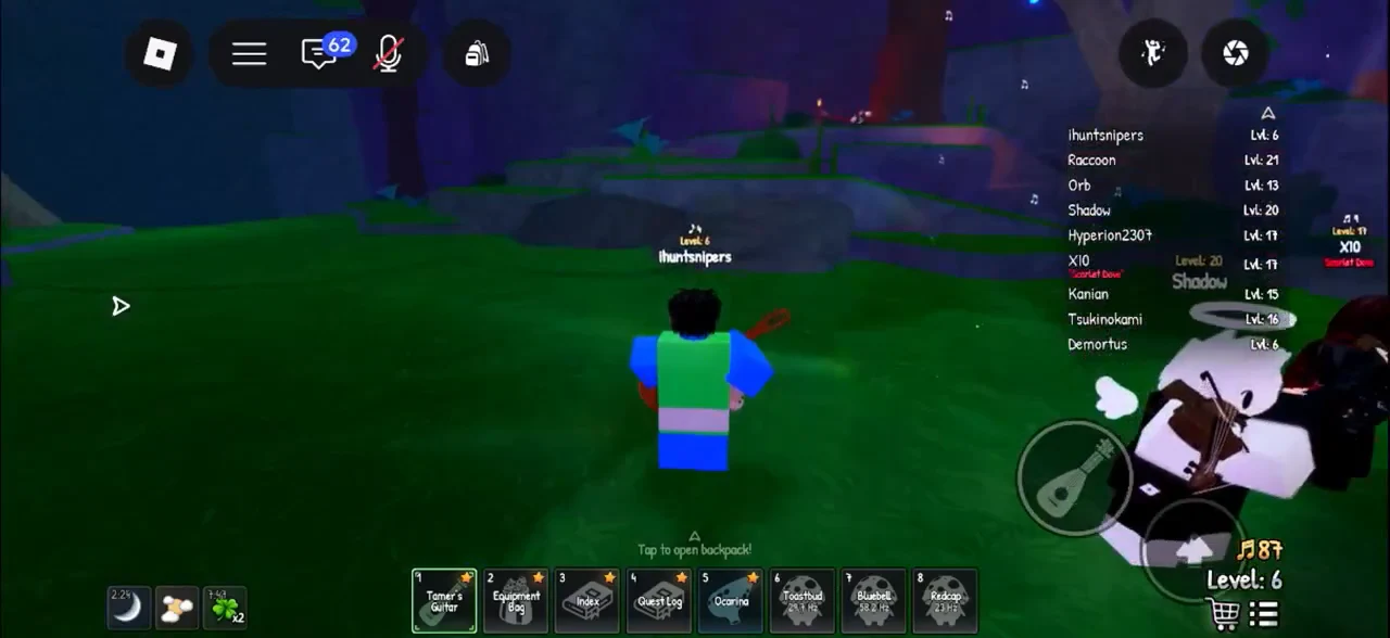 Tamer's Guitar highlighted in hotbar slot 1 while the avatar stands in a grassy area