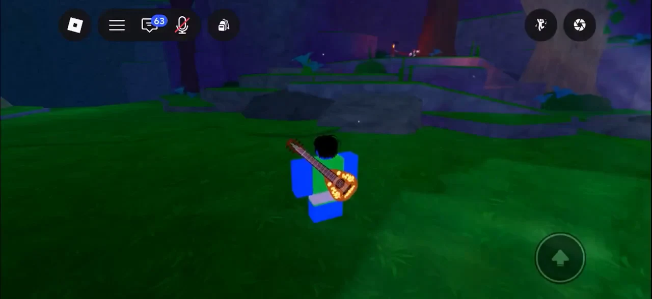 Guitar-equipped avatar in a grassy area with the on-screen jump button ready