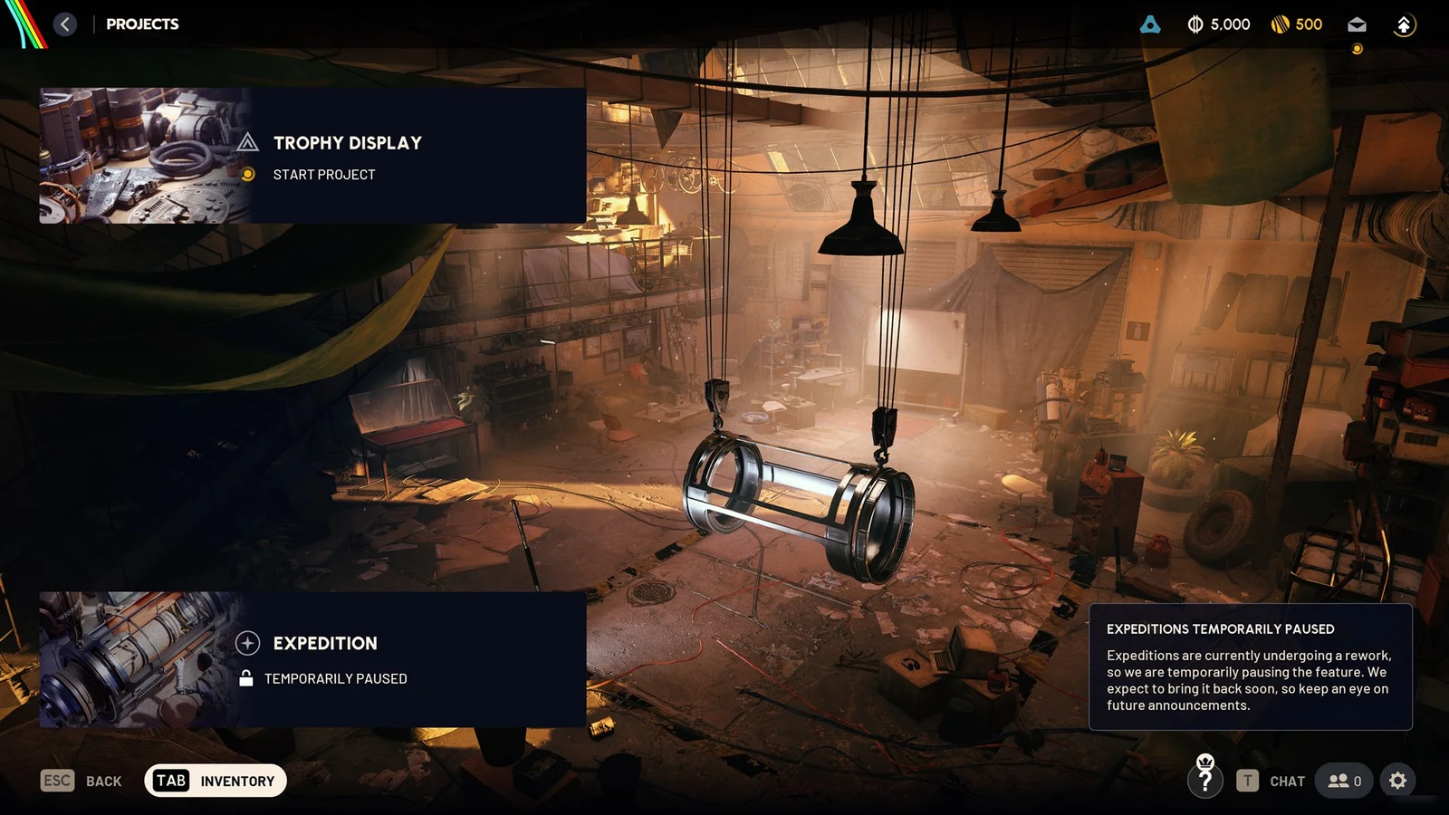 Projects menu over a workshop scene with Trophy Display and Expedition entries and a notice that expeditions are paused.