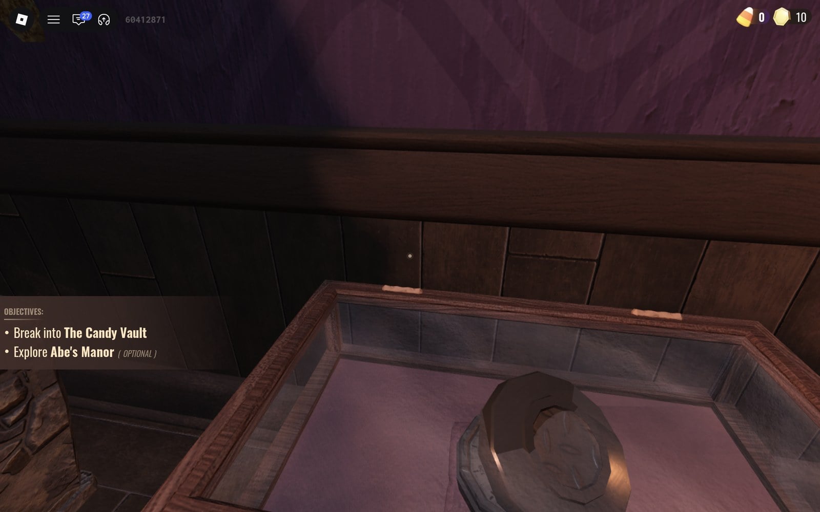 Locked glass case on the upstairs gallery holding a bronze medallion with a crescent shape in DOORS