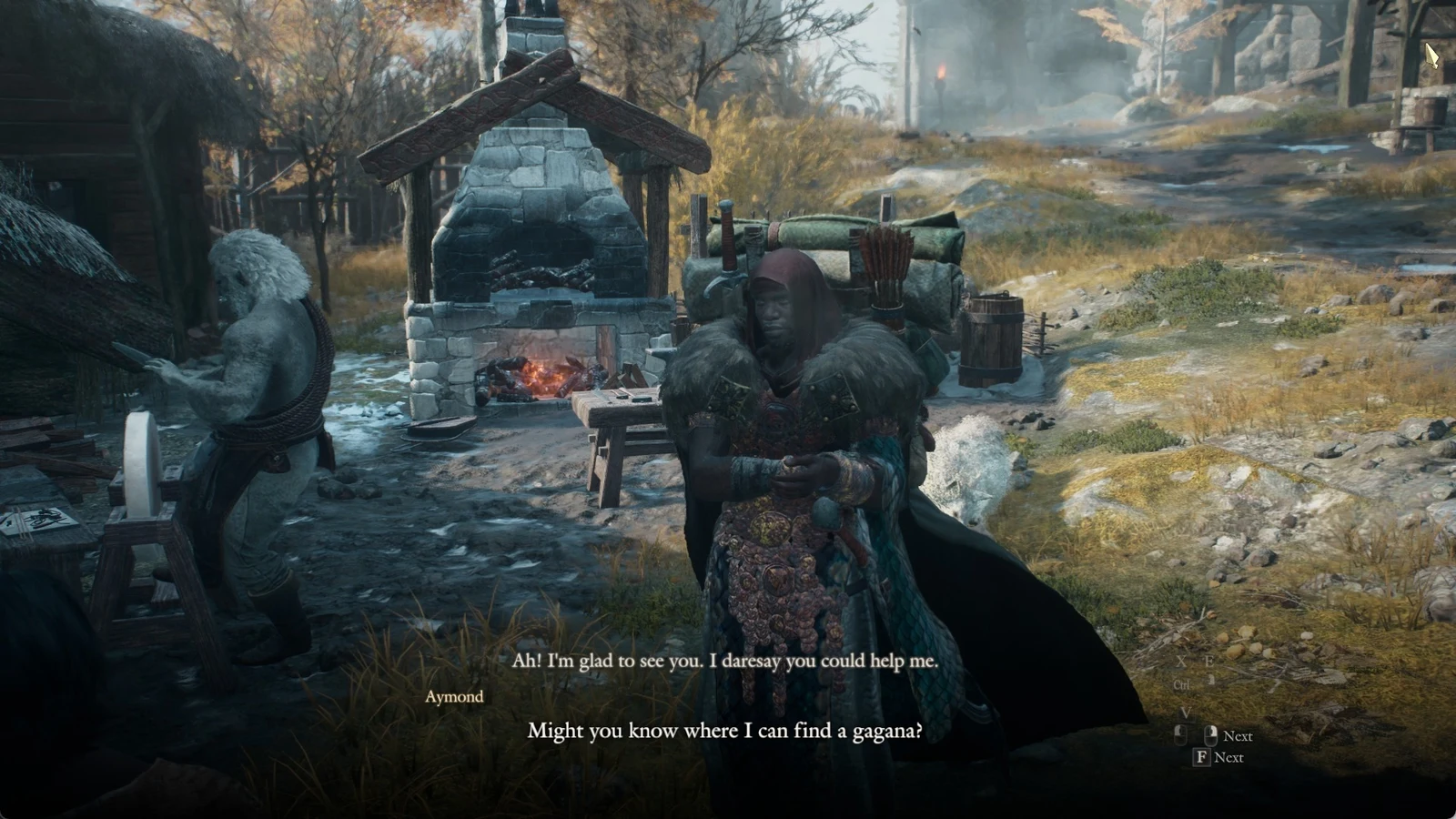Hooded armored man in a fur collar speaks beside a stone forge while a pale figure works at a grindstone nearby.