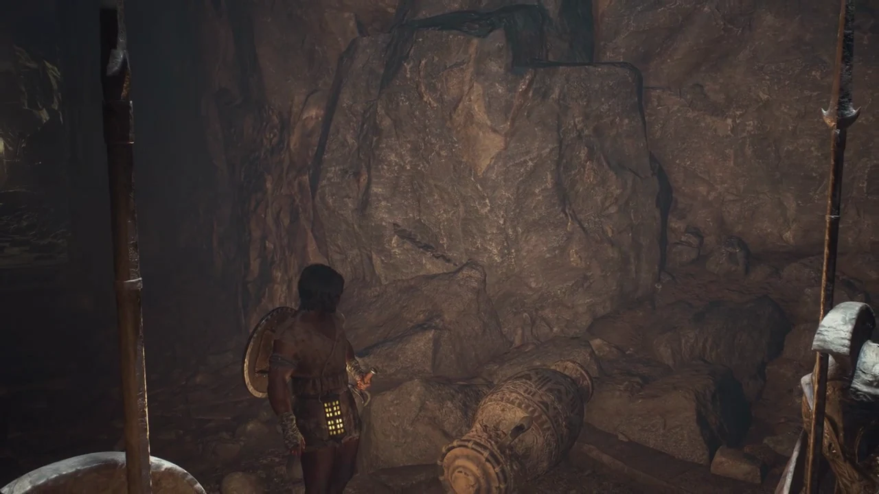 Character holds a torch in a rocky cave beside a fallen barrel