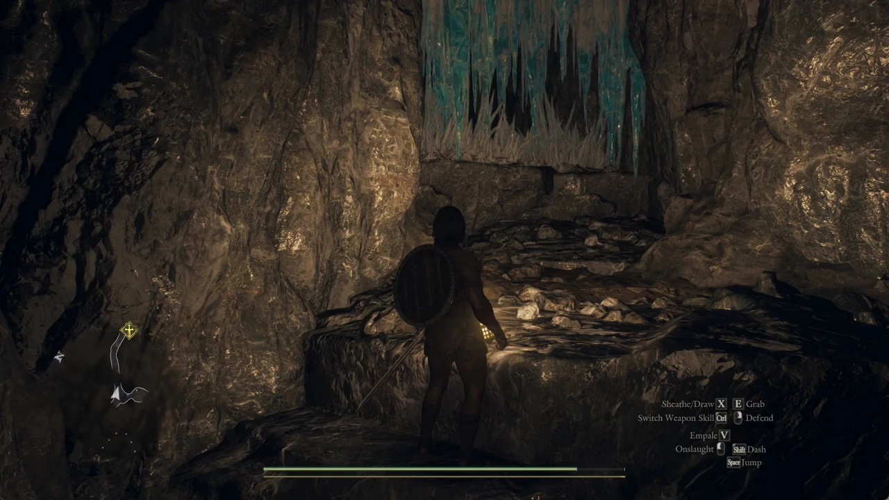 Character heading toward a rocky stairway beneath hanging blue ice spikes in a cave