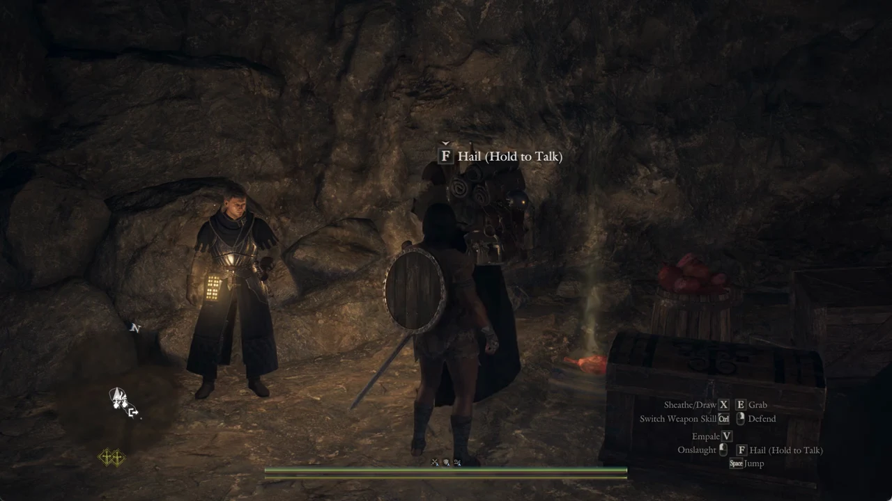 The F Hail Hold to Talk prompt showing as the Arisen approaches Aymond at the back of the cave camp