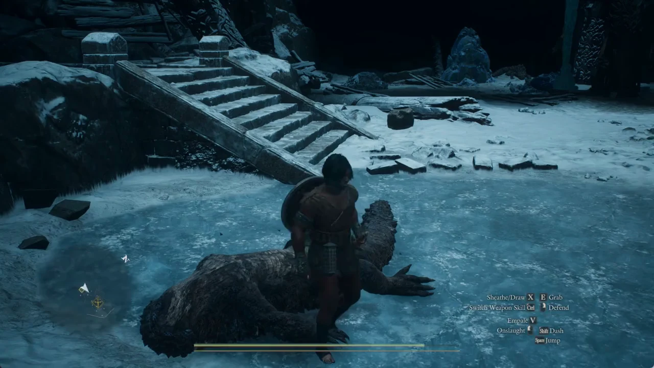 Arisen standing over a downed reptilian enemy in an icy cave with the Grab prompt showing