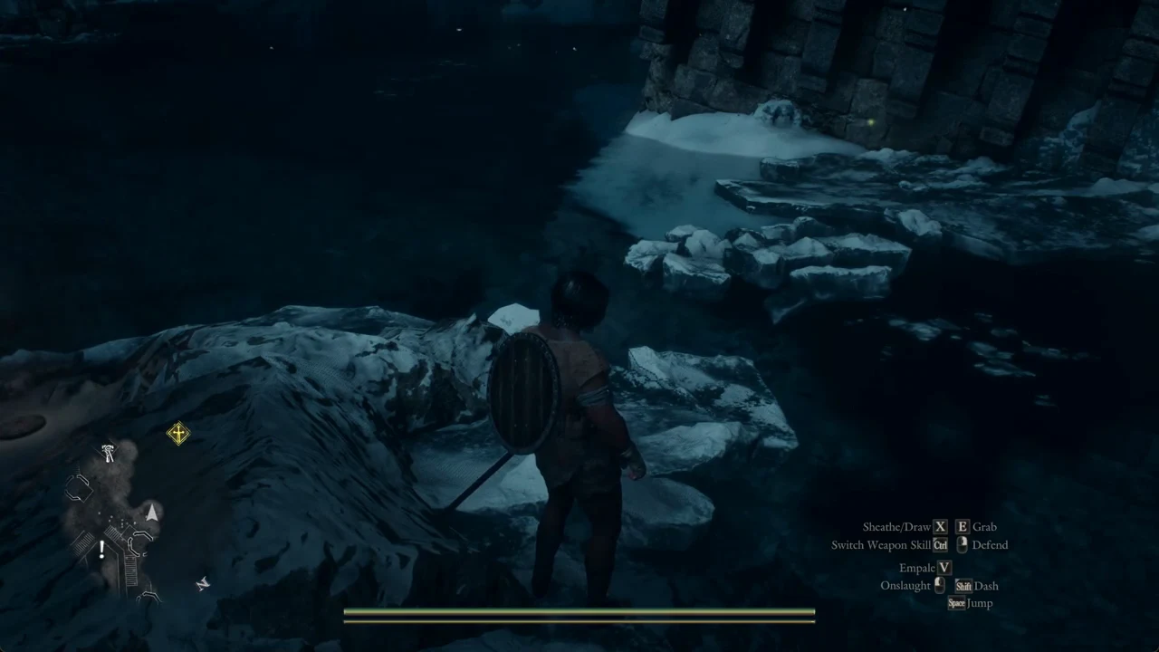 Character on snowy rocks beside dark water facing a yellow waypoint marker with the gameplay HUD