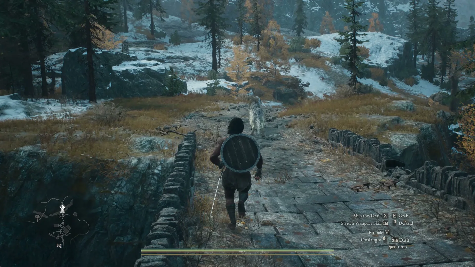 Freki trots ahead of the Arisen over the stone bridge outside the settlement, snowy pines beyond