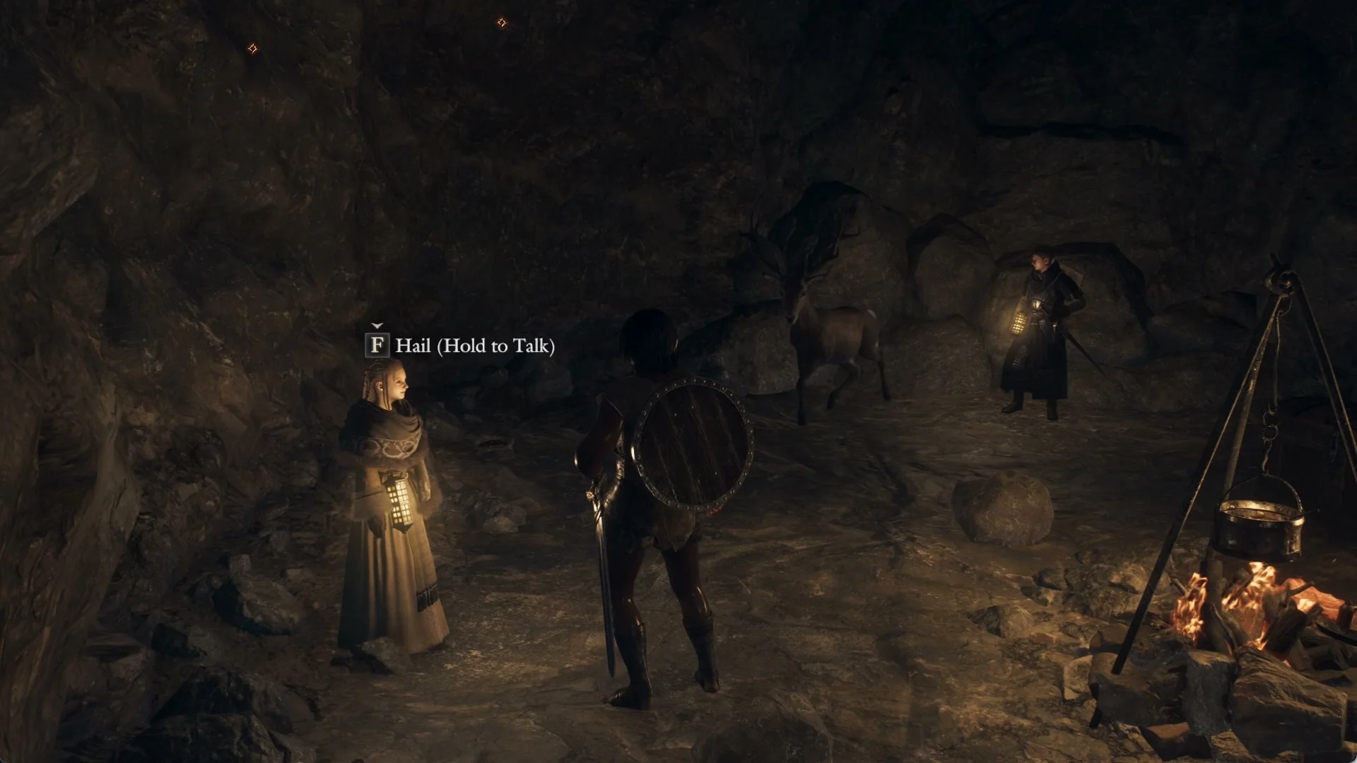 Ilda holding a lantern by the rock wall of the cave camp, with the hail prompt above her and the cooking pot over the campfire on the right