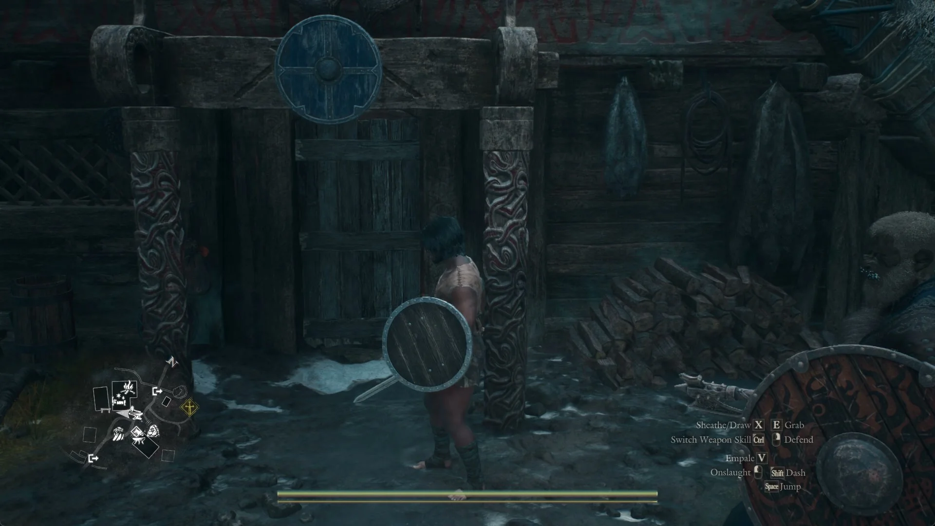 The door of the Norgandian Inn, set in a carved wooden frame with a round blue shield hung above it.