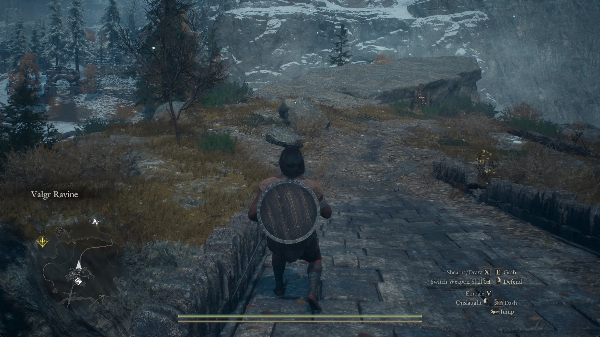 The Arisen walking north across the paved stone bridge out of the Norgandian Settlement with the area name Valgr Ravine on screen
