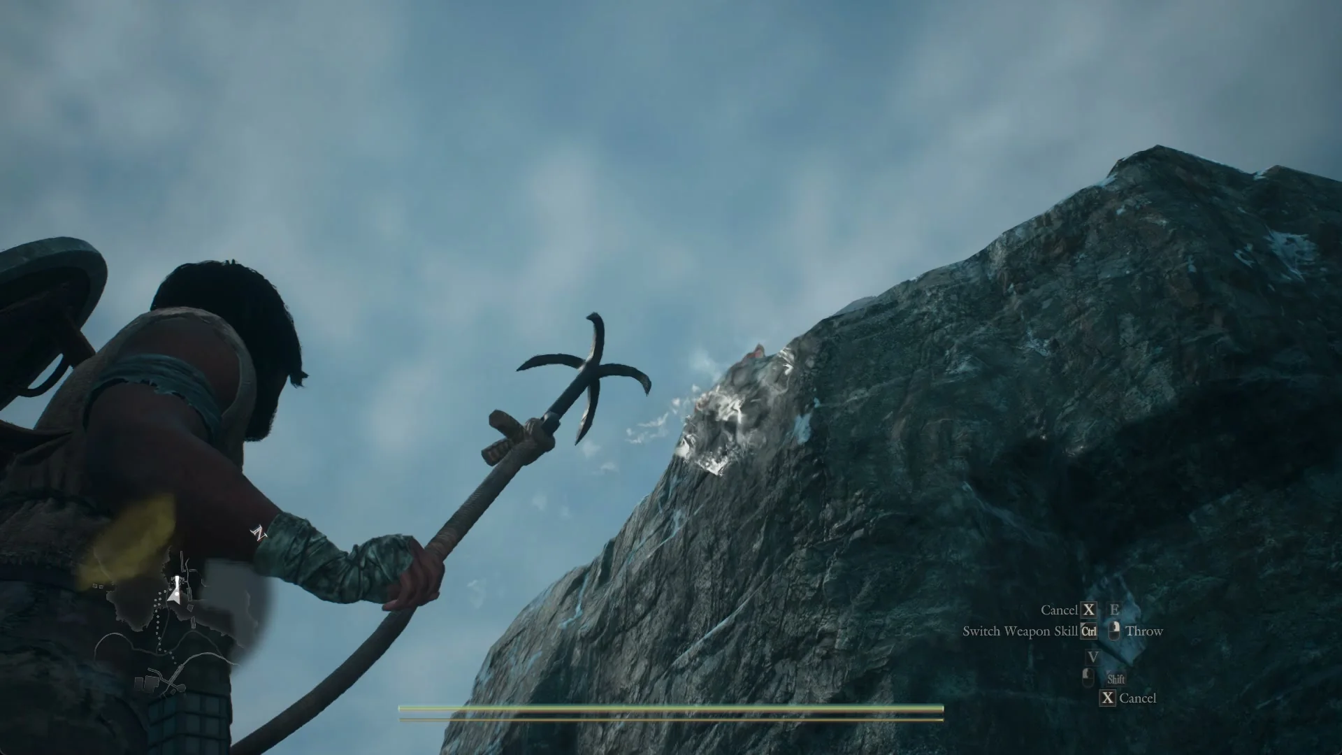 Aim view below the cliff with a white aiming mark on the rock face beside the tether post