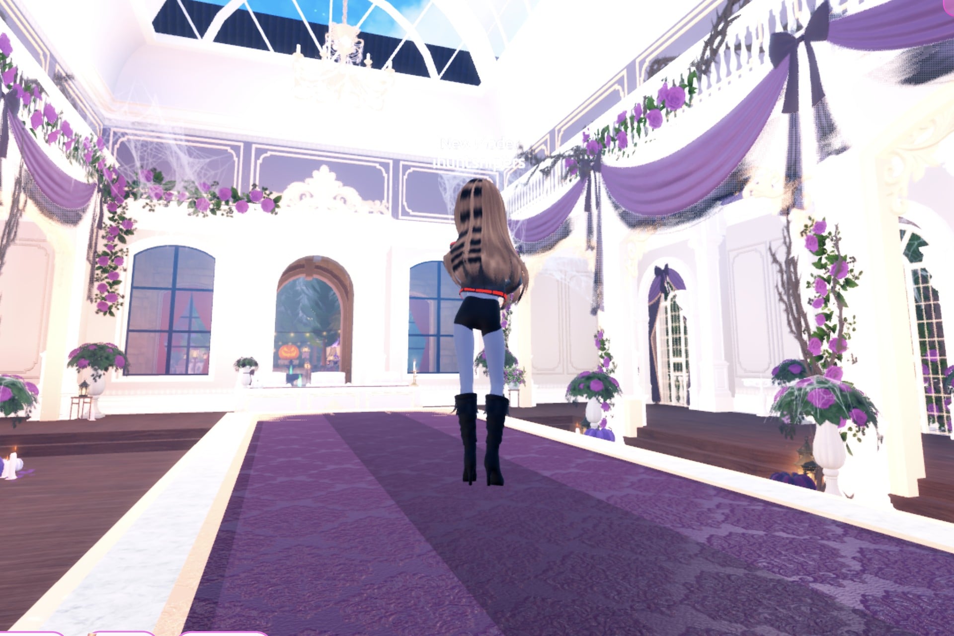 Back view of the rock cover look on the Freeplay Runway: long wavy hair over the black jacket, black knee boots