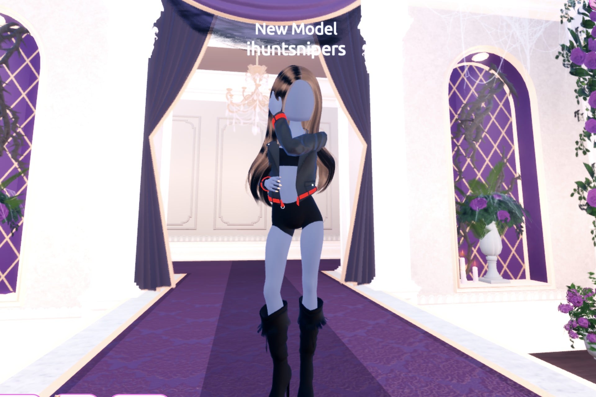 Front view of the rock cover look on the Freeplay Runway: black leather jacket with a red band, black top and shorts, black leather knee boots, Satin pose