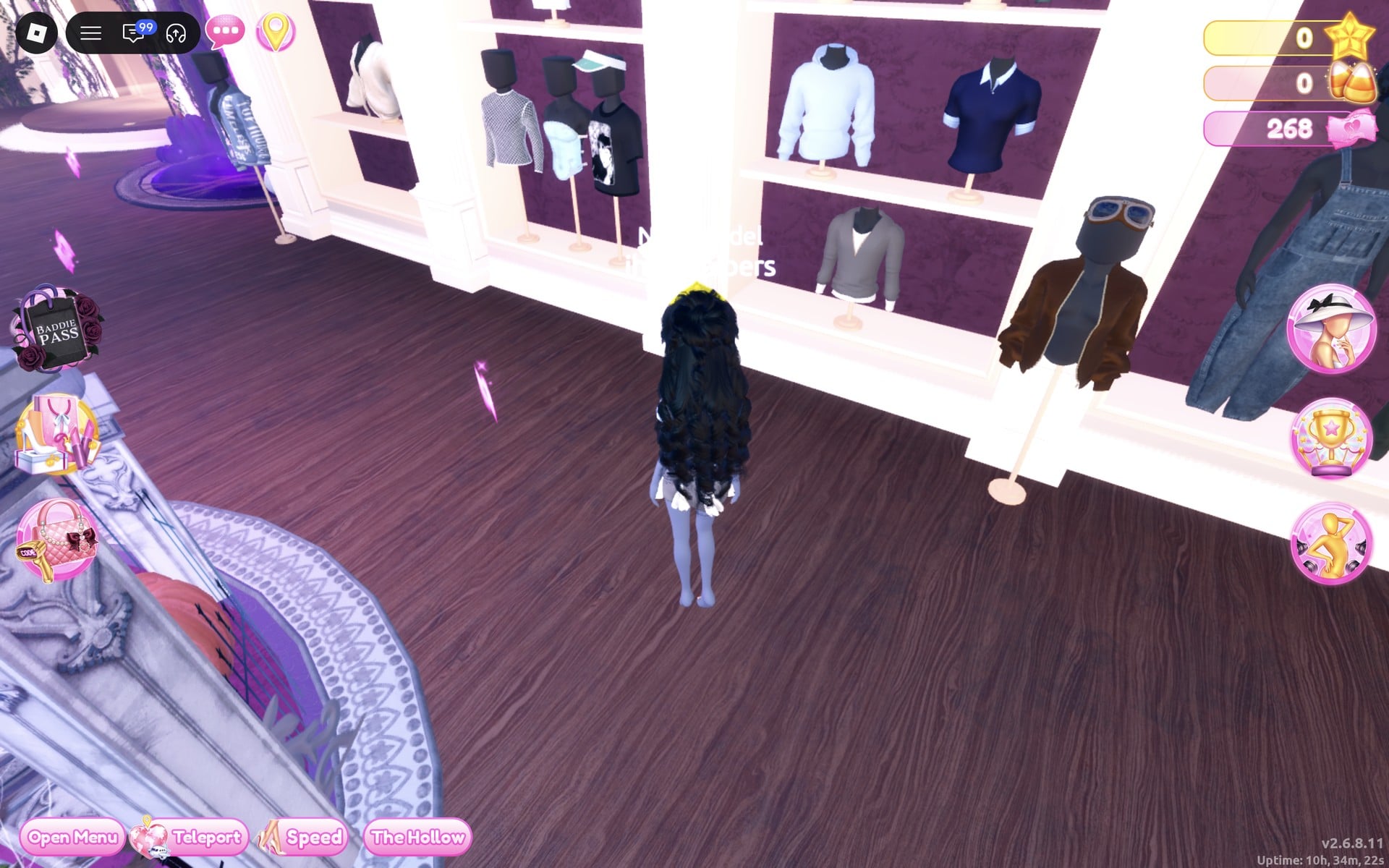 The men's-wear wall beside the Halloween display circle: shelves of tops and a brown bomber jacket on a floor stand at the right