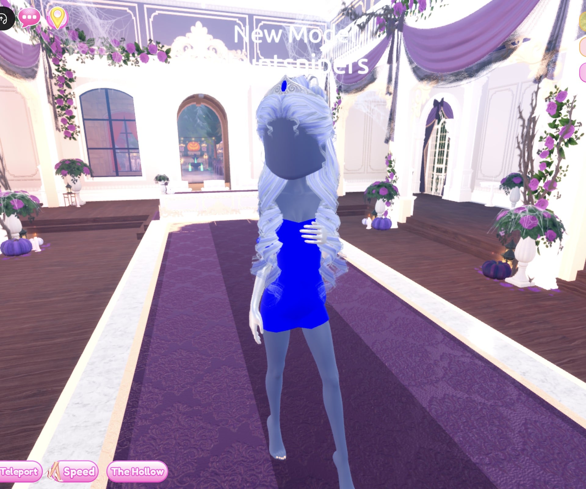 Sapphire look on the Freeplay Runway: blue strapless mini, silver gloves, icy pale blue curls and a silver tiara with a dark blue gem, one hand at the chest